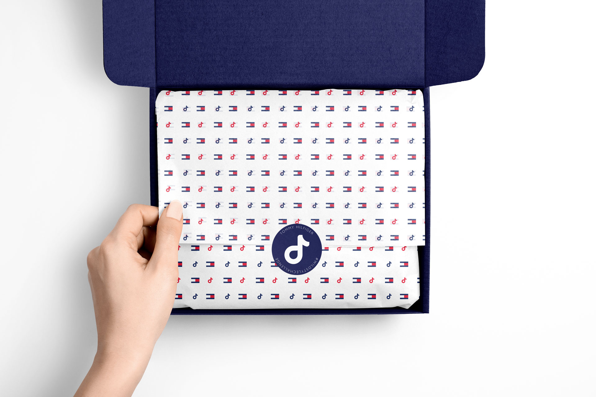 Tommy Hilfiger × Normani tissue paper or gift bag interior detail — campaign branding on material surface showing texture and craft